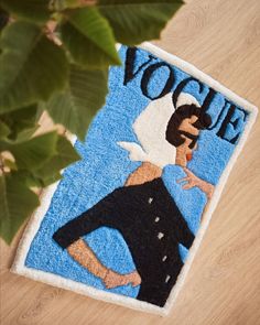 a rug with an image of a woman on it and the words voie written in blue