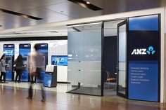 people are standing in line at an atm machine that is blue and white with the words amz on it