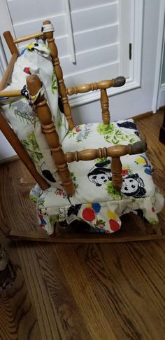 a child's rocking chair with panda print on it