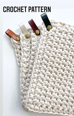 two crocheted bags with leather handles on them