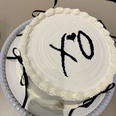 a white cake with black icing and the number six on it