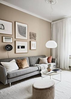 a living room filled with furniture and pictures on the wall