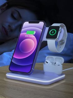 an apple watch and ear buds are connected to the charging dock in front of a woman's face