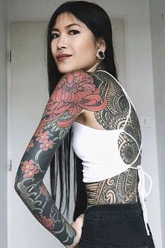 a woman with tattoos on her arms and shoulder