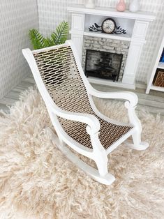 a white rocking chair sitting on top of a shaggy rug in front of a fireplace