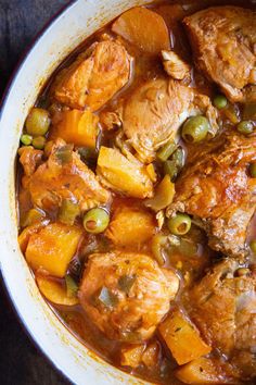 a white bowl filled with meat and vegetables