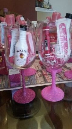 pink wine glasses are sitting on a table