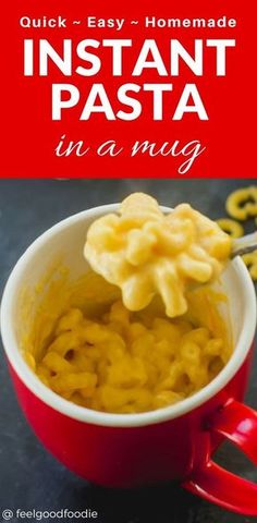 a red cup filled with macaroni and cheese on top of a black table