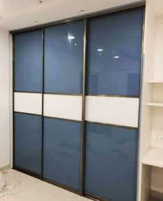 an empty room with blue and white sliding doors