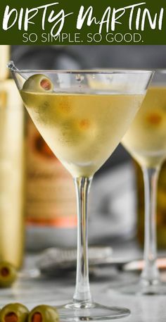 two martini glasses filled with white wine and olives