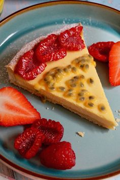 a piece of cheesecake with strawberries and kiwis on a blue plate