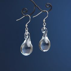 "These Clear teardrop earrings are made of glass in lampwork technique. The stainless steel hooks are hypoallergenic. They will not tarnish, fade, or discolor with time. These unique and beautiful earrings are like water drops frozen in glass! They are simple and elegant, very lightweight and comfortable to wear, perfect for everyday wear and for special occasions. You will definitely receive lots of compliments on your new earrings, everybody loves them, and you'll love them too! Dimensions: to Nickel-free Glass Drop Jewelry, Water Drop Jewelry, Modern Glass Teardrop Earrings, Minimalist Teardrop Glass Jewelry, Glass Drop Earrings With Matching Set, Glass Drop Earrings As Gift, Glass Teardrop Jewelry With Matching Earrings, Modern Hypoallergenic Teardrop Drop Earrings, Modern Hypoallergenic Drop Teardrop Earrings