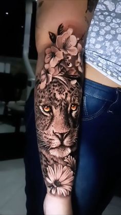 a woman's arm with a leopard and flowers on it