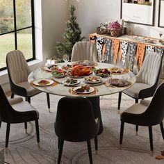 a dining room table is set with plates and silverware