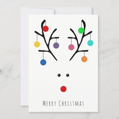 a christmas card with a reindeer's face and colorful balls on it