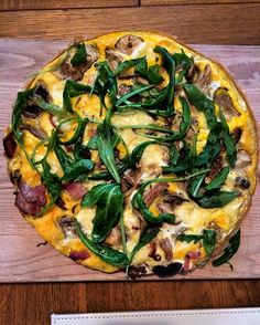 a pizza sitting on top of a wooden cutting board