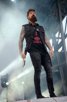 a bearded man standing on top of a stage