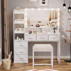 a white vanity with lights on it in a room next to a chair and rug