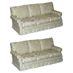 two couches sitting next to each other on a white background