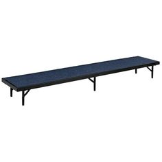 a black bench sitting on top of a white wall next to a blue carpeted floor