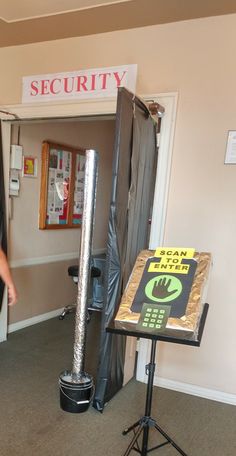 a man standing in front of a microphone next to a sign with the word security on it