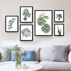 a living room filled with furniture and pictures on the wall