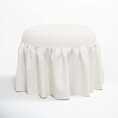 a white stool with a ruffled skirt on it