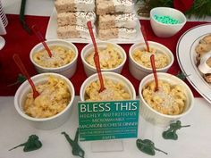 there are many desserts on the table with red and green decorations around them, including rice krispy kreme treats