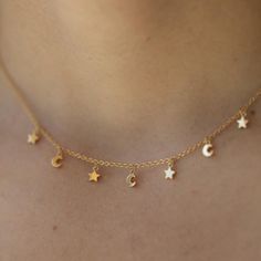 The Star & Moon Choker Necklace in Gold is here to add a little celestial charm to any look. This necklace features dainty gold chain and star and moon charms that sparkle like the night sky. 14" with two 1" extenders 3mm star and moon charms Comes packaged on a necklace card Heavy 18k Gold Plate over brass with e-coating for extra longevity ** Our pieces are plated 1 micron thick, industry standard is .125. Quality & longevity are extremely important to us. We wanted to ensure these pieces will Moon Choker Necklace, Moon Choker, Dainty Gold Chain, Star And Moon, Star Moon, Moon Charm, The Night Sky, Stars And Moon, The Star