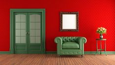 a living room with red walls and green furniture