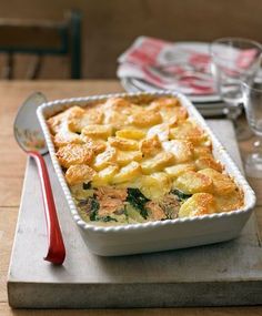 a casserole dish with potatoes and spinach