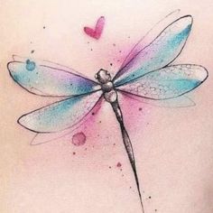 a watercolor tattoo with a dragonfly on the back of a woman's shoulder