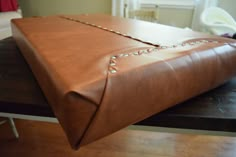 a large brown bag sitting on top of a wooden table