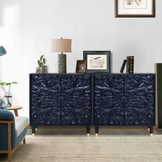 a living room with blue furniture and pictures on the wall