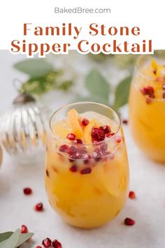 two glasses filled with orange and pomegranate drink on top of a table