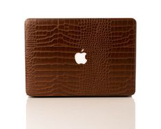 an apple macbook air case in brown crocodile skin