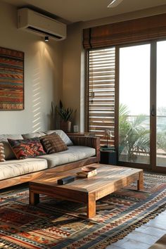 a living room filled with furniture and a large window covered in shuttered glass doors