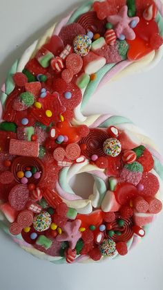 a cake shaped like the letter s with candy and candies on it