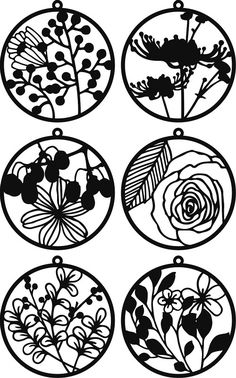 four circular ornaments with flowers and leaves on them, each one in black and white