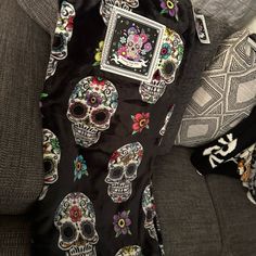 a couch covered in skulls and flowers on it