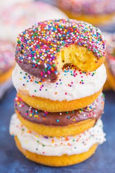 a stack of doughnuts with different colored sprinkles