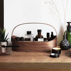 an assortment of skin care products displayed on a wooden table with succulents