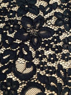 an image of black lace with flowers on it