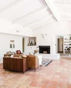 a living room with two couches and a fire place in the middle of it