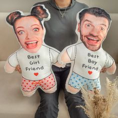 two people sitting on a couch with their faces cut out to look like they are hugging each other