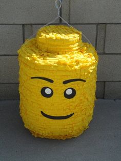 a yellow brick with a face made out of it