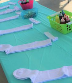 the table is set up with blue and white napkins on it, along with cupcakes