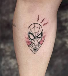 a spider - man tattoo on the leg with bats coming out of his head and eyes