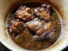 meat and vegetable stew in a bowl on the stove top, ready to be eaten