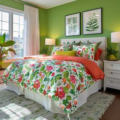 a bedroom with green walls and floral bedding